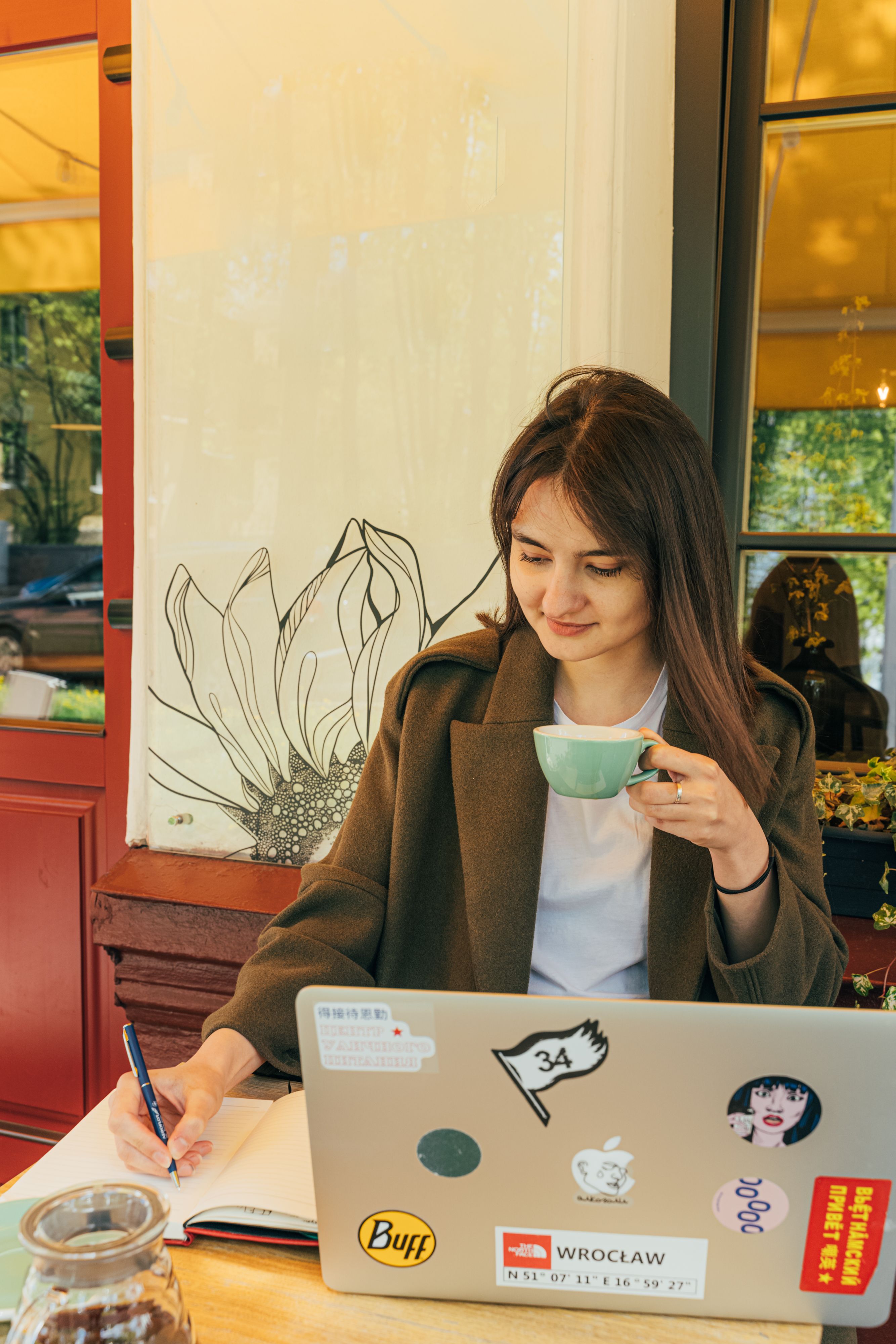 A language student taking notes over coffee while studying